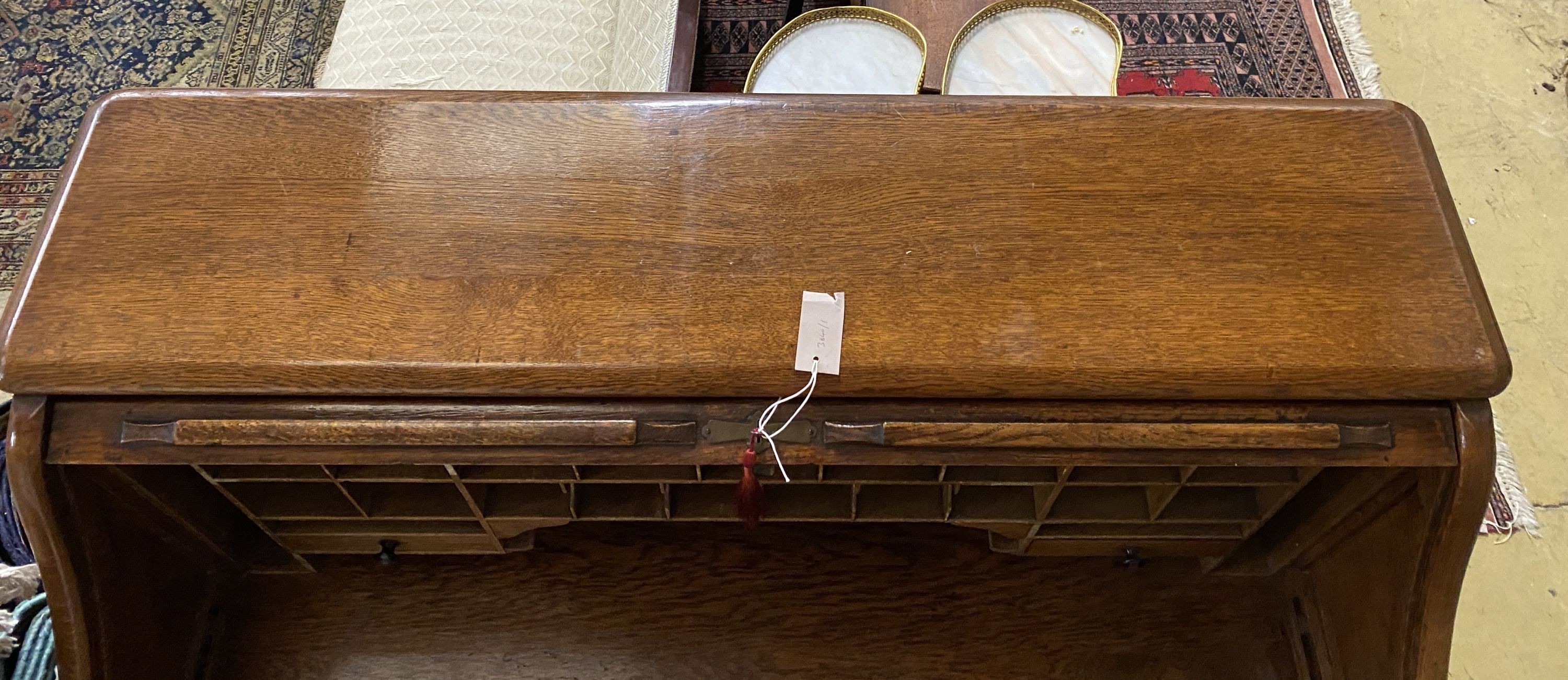 An early 20th century oak roll top desk with 'S' shaped tambour, width 122cm, depth 78cm, height 124cm